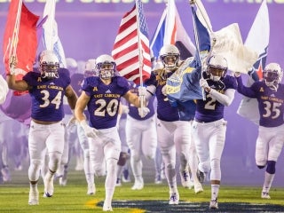 Football team running on the field