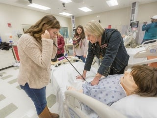 Teacher and Student work with a practice dummy