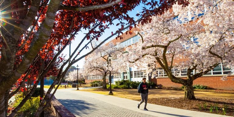 Student walks on the ECU campus near Wright Plaza