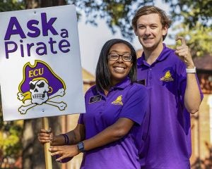 Ask a Pirate student sign holders answer questions