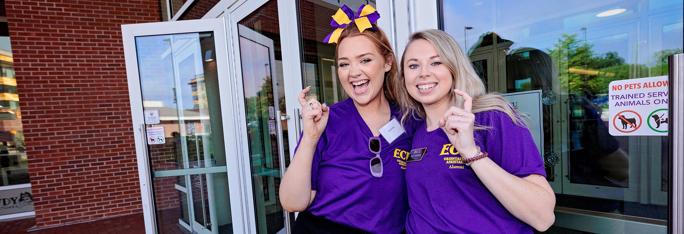 Austin Vick, left, and Emily Wiggins welcome people to campus for orientation. (ECU photo by Cliff Hollis)